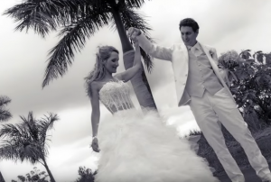 Newly wed couple dancing barefoot on beact after their beach wedding